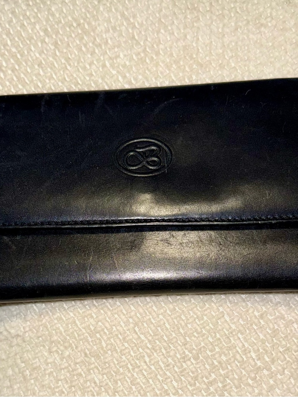 Black Leather Folded Clutch Wallet with Embossed Oval Logo